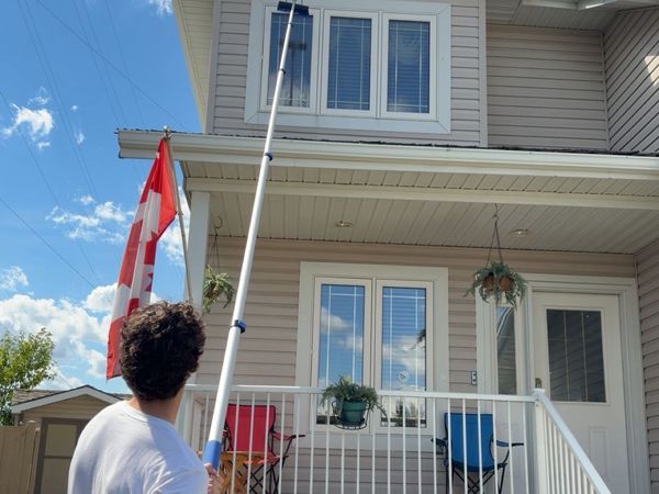 Team cleaning upper storey windows